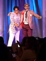 Buford onstage with a volunteer